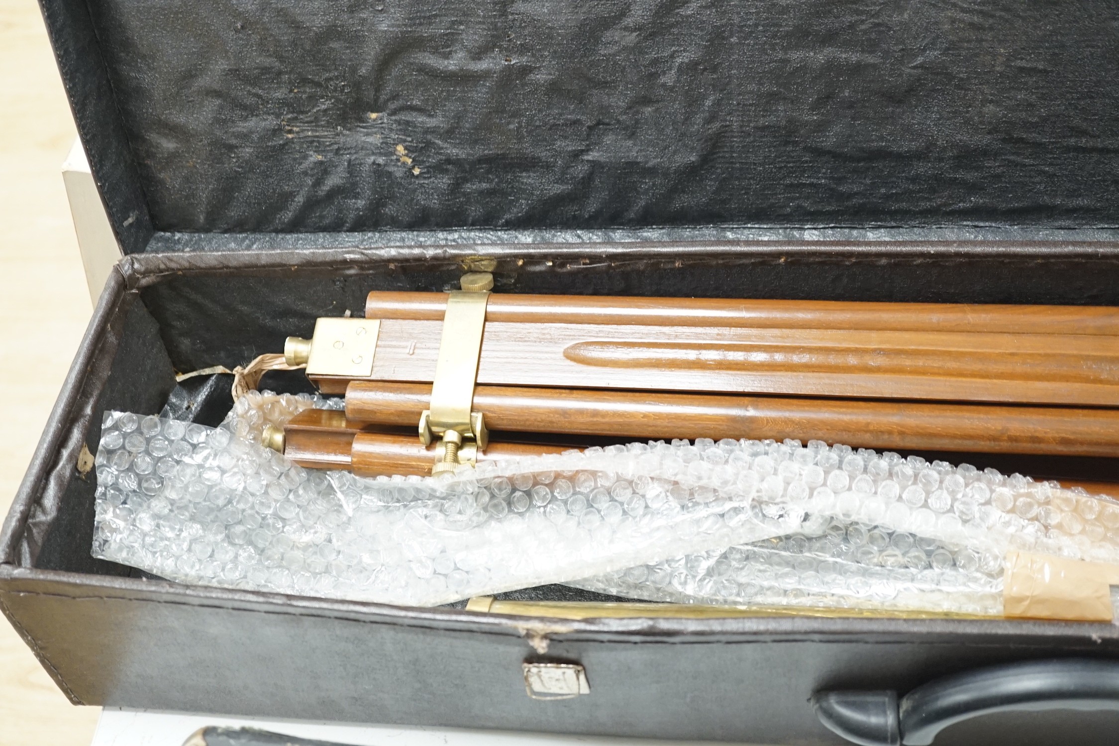 A cased brass telescope and tripod stand, together with a CorTon for Paxman French horn (cased)